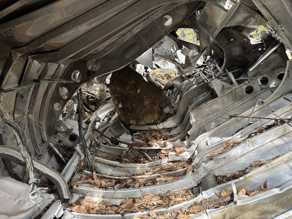 Fuselage piece among rocks